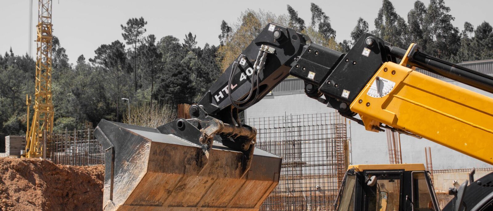 Utah contractors comparing equipment rental options at a modern rental facility with heavy machinery and fleet vehicles