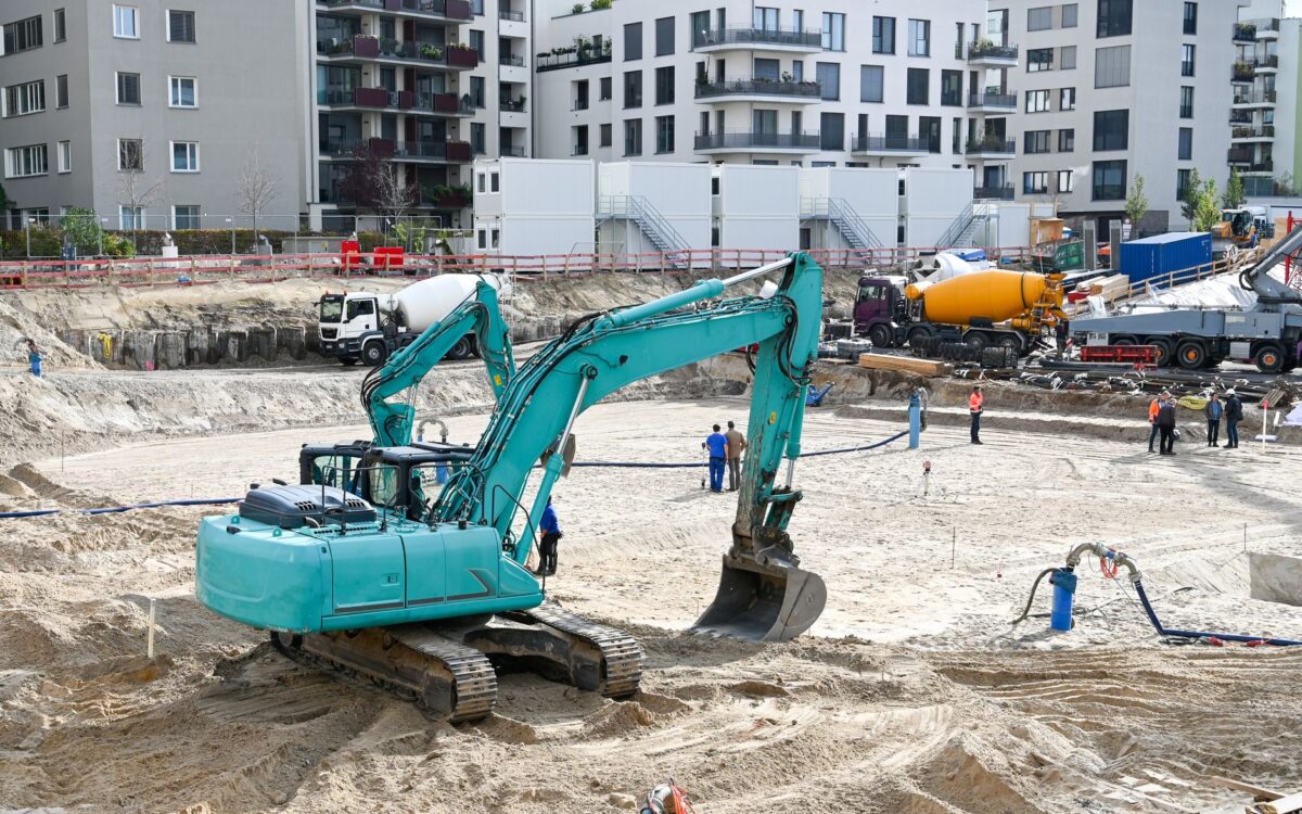 Construction site in Utah showing heavy equipment rental checklist preparation with contractors reviewing machinery