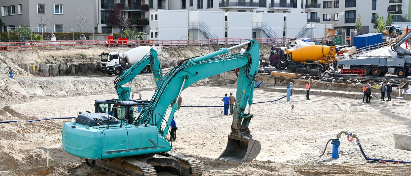 Construction site in Utah showing heavy equipment rental checklist preparation with contractors reviewing machinery