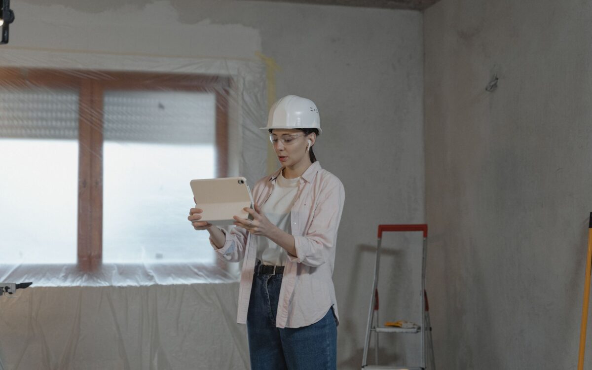 Utah contractor using equipment rental management software on tablet to track costs and reduce downtime on active construction job site