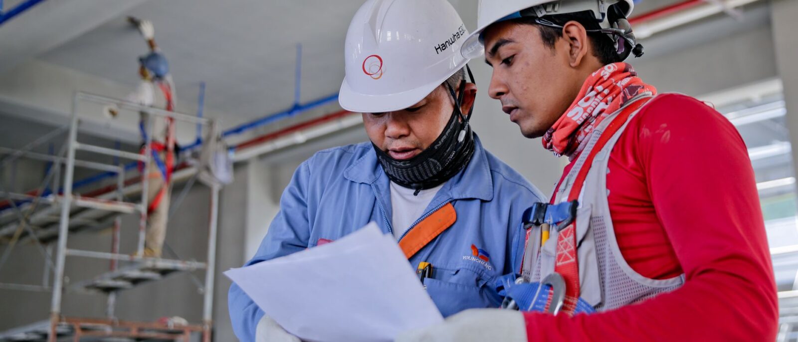 Utah contractor using equipment rental ROI calculator on tablet at construction project site