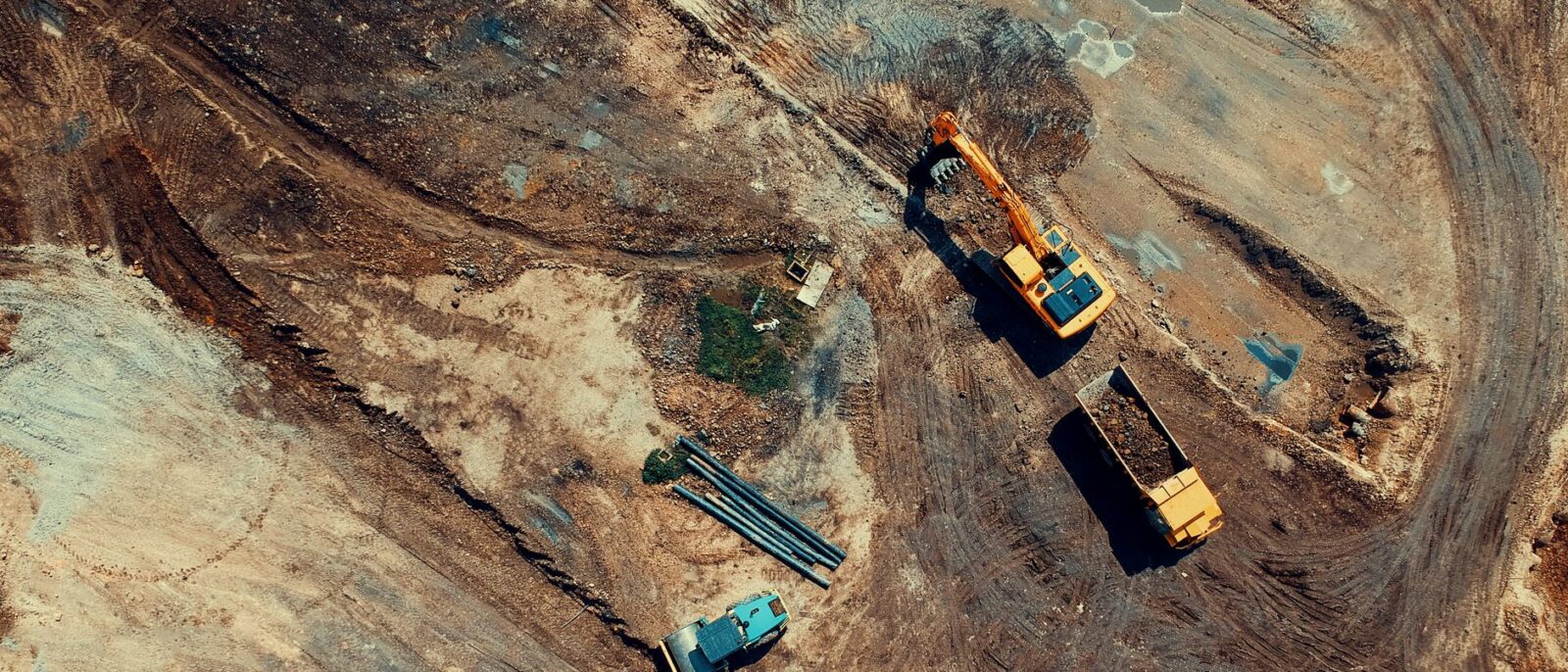 Heavy equipment rental yard in Utah featuring excavators, bulldozers, and cranes ready for contractor projects