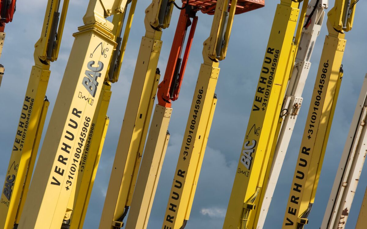 Construction workers using aerial lift equipment on Utah job site for building renovation project
