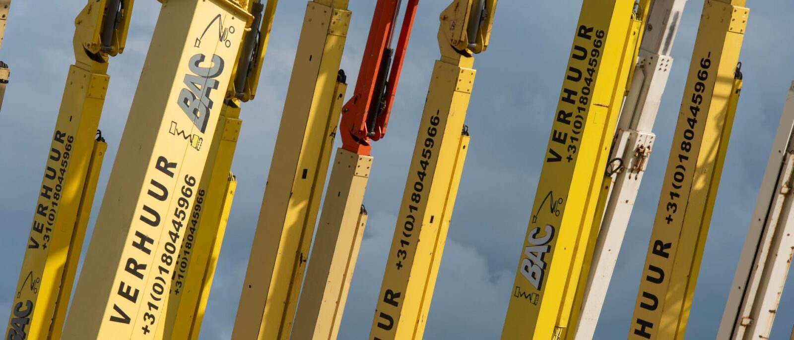 Construction workers using aerial lift equipment on Utah job site for building renovation project