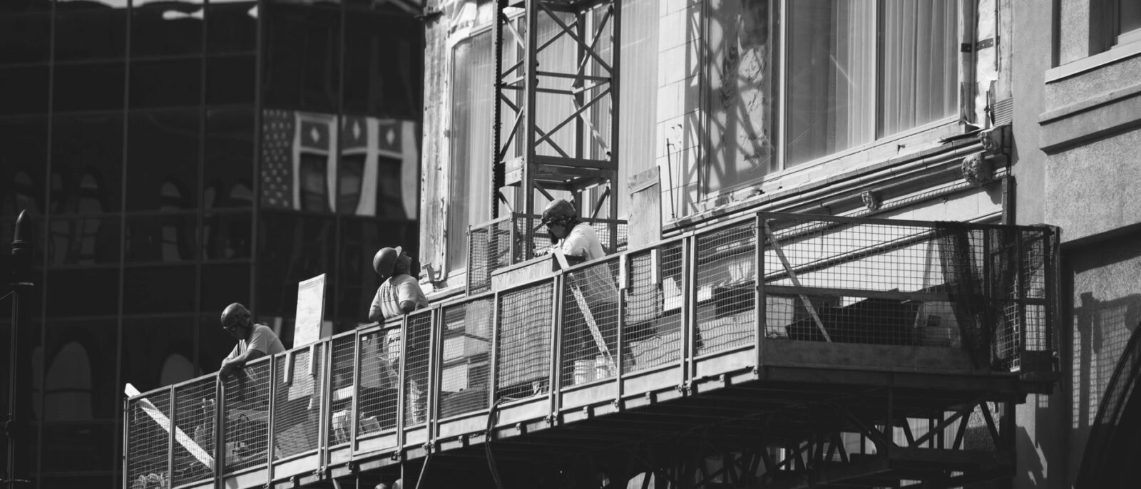 Yellow construction lift rental on active job site with Utah city skyline, showing lift rental costs and equipment for construction projects