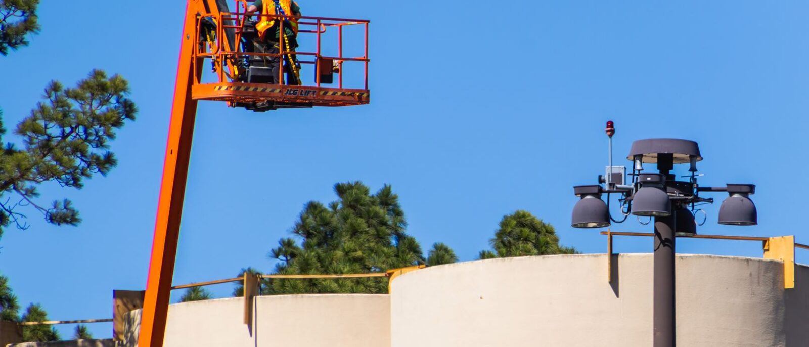 Lift rental equipment on active Utah construction site showing boom lift and scissor lift for budget planning