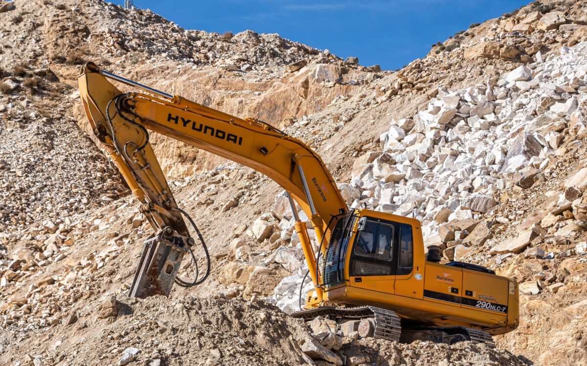Construction equipment delivery truck arriving at Utah job site with same-day rental equipment for contractors