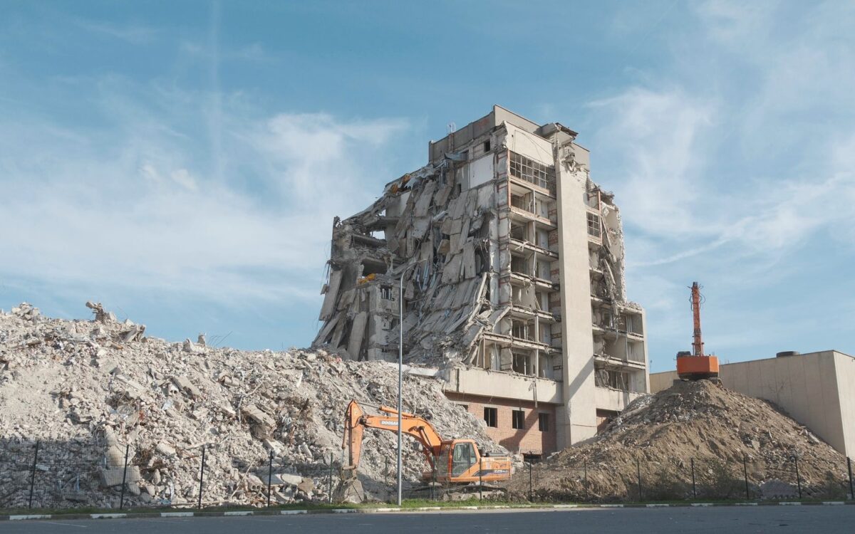 Urban demolition scene with a digger at a construction site in Volgograd.