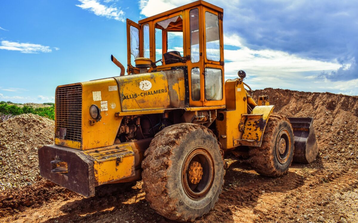A yellow bulldozer on a construction site, highlighting heavy machinery in action.