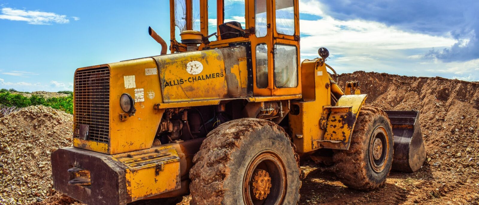 A yellow bulldozer on a construction site, highlighting heavy machinery in action.