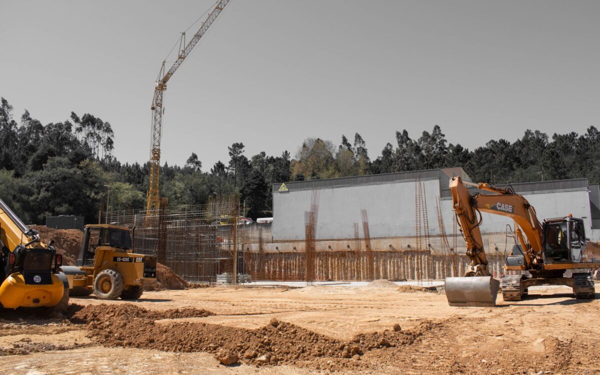 A busy construction site with cranes and heavy machinery for building infrastructure.