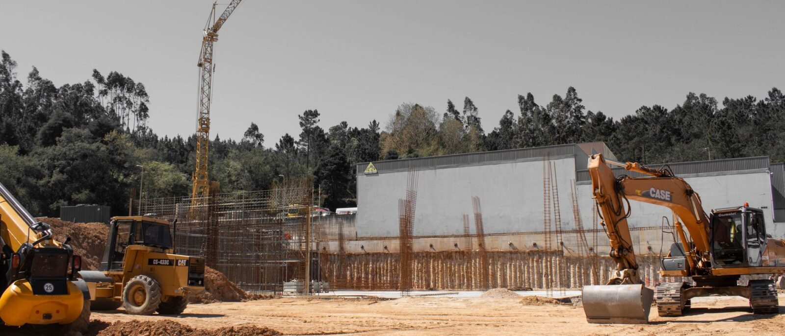 A busy construction site with cranes and heavy machinery for building infrastructure.