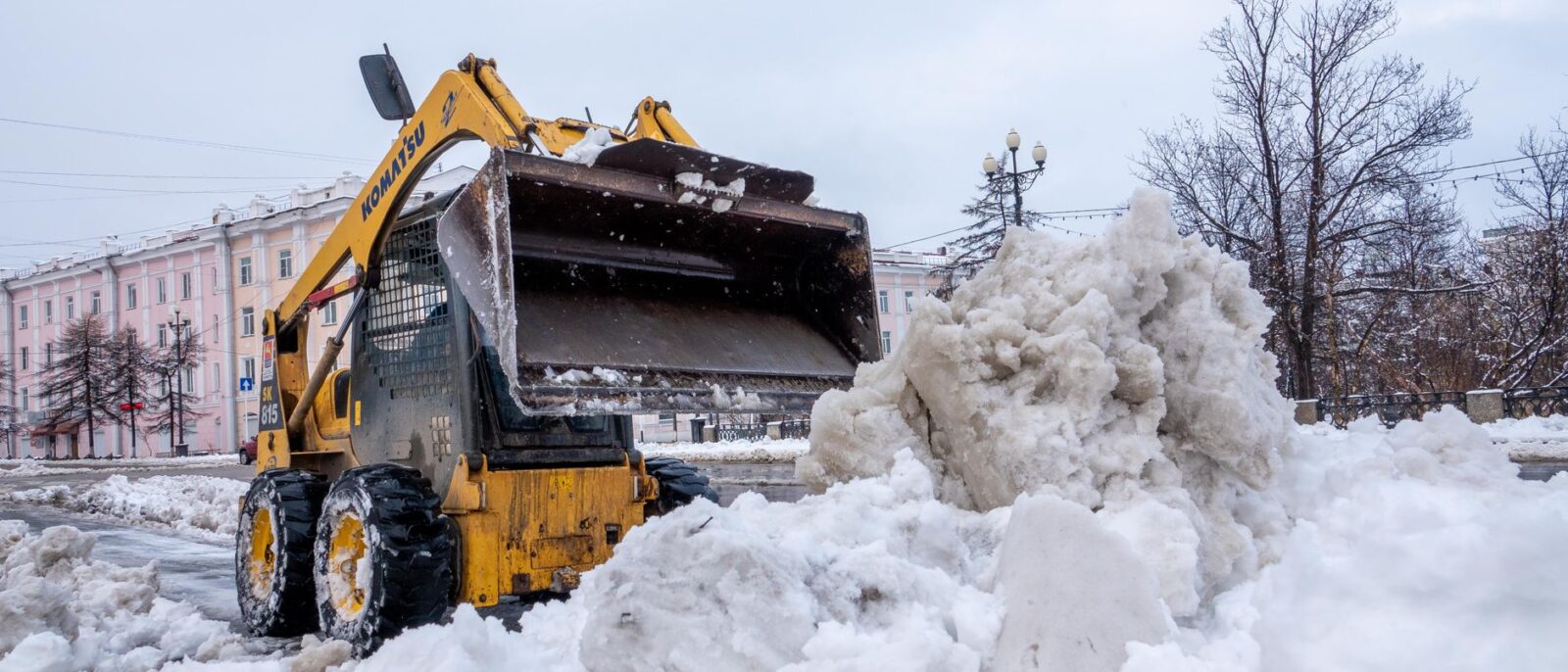 Yellow skid steer rental Utah equipment parked on active construction job site ready for deployment