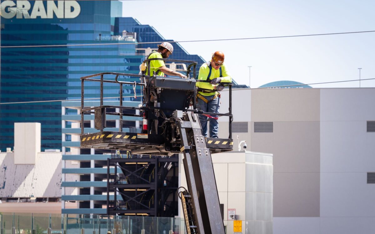 Construction workers perform exterior maintenance on a high-rise in Las Vegas.